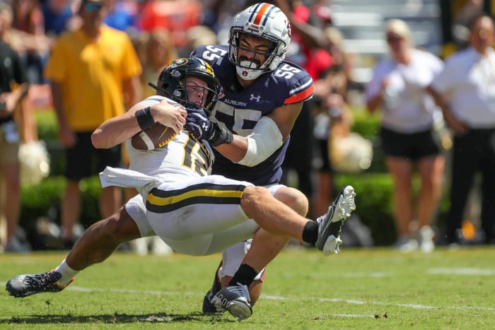 Auburn Tigers linebacker Eku Leota (55) wraps up Missouri Tigers quarterback Brady Cook (12) in the backfield during Auburn's 17-14 victory at Jordan-Hare Stadium on Sept. 24, 2022.